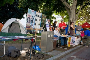 Tables for organizations at OccupyLA, up a curb, making staffing at such a table, difficult for a person in a wheelchair. 